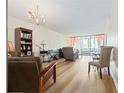 Bright living room featuring wood floors and sliding glass doors at 19029 Us Highway 19 N # 3-1, Clearwater, FL 33764