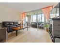 Inviting living room with a fireplace and a seamless transition to the sunroom at 19029 Us Highway 19 N # 3-1, Clearwater, FL 33764