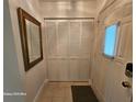 Hallway featuring a closet with white doors and a decorative mirror at 2221 Norwegian Dr # 15, Clearwater, FL 33763