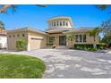 Elegant two-story home with a circular tower, manicured landscaping, and a spacious driveway at 2279 Mermaid Ne Pt, St Petersburg, FL 33703