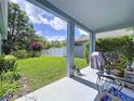 This covered patio is perfect for outdoor entertaining with a view of the lush backyard at 4315 Whittner Dr, Land O Lakes, FL 34639