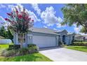 This single-story home features a well-maintained lawn, beautiful landscaping, and an attached two-car garage at 4315 Whittner Dr, Land O Lakes, FL 34639