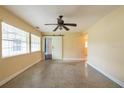 Bright bedroom with large windows, ceiling fan, barn door and speckled flooring at 4323 S Lois Ave, Tampa, FL 33611