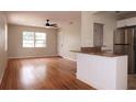 Open-concept living space with hardwood floors, a ceiling fan, and a convenient breakfast bar at 4572 33Rd N Ave, St Petersburg, FL 33713