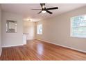Inviting living room featuring gleaming hardwood floors, a ceiling fan, and ample natural light at 4572 33Rd N Ave, St Petersburg, FL 33713