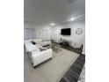 Bright living room featuring a comfortable sectional sofa and modern decor at 4743 Deer Track St, Tampa, FL 33610