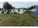 Side view of the light green single-story house with chain link fence at 4920 S 82Nd St, Tampa, FL 33619
