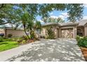 Inviting home with well-kept lawn, garden, and attached garage, offering great curb appeal at 5143 Lochmead Ter, Zephyrhills, FL 33541