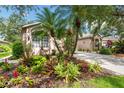 Well maintained yard featuring beautiful and colorful tropical landscaping at 5143 Lochmead Ter, Zephyrhills, FL 33541