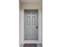 Elegant front door with a secure lock system and gray trim at 6043 Piedmont Dr, Spring Hill, FL 34606