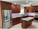 Modern kitchen featuring stainless steel appliances, an island, and beautiful wooden cabinetry at 6474 29Th N Ave, St Petersburg, FL 33710