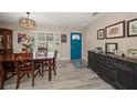 Open dining area with natural light, stylish light fixture, shutters and wood-look floors at 670 42Nd Ne Ave, St Petersburg, FL 33703