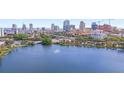 Scenic aerial view of a lake with a fountain and a city skyline in the background on a sunny day at 701 Mirror Lake N Dr # 103, St Petersburg, FL 33701