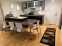 Modern kitchen features stainless steel appliances, granite countertops, and an island with seating at 701 S Madison Ave # 410, Clearwater, FL 33756