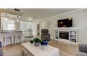 Inviting living room with a fireplace, hardwood floors, neutral walls, and a view of the kitchen and dining area at 755 Green Valley Rd, Palm Harbor, FL 34683