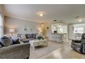 Comfortable living room featuring hardwood floors, neutral walls, and an open layout to the dining and kitchen area at 755 Green Valley Rd, Palm Harbor, FL 34683