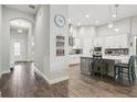 Modern kitchen with white cabinets, stainless steel appliances, a kitchen island, and stylish backsplash at 808 Vittorio Pl, Brandon, FL 33511