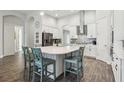 Spacious kitchen island with seating, white countertops, and ample storage perfect for meal prep and casual dining at 808 Vittorio Pl, Brandon, FL 33511