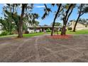 Beautiful home with mature trees, manicured lawn, and red mulch beds creating lovely curb appeal at 8222 Valrie Ln, Riverview, FL 33569