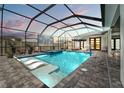Relaxing screened-in pool area with a hot tub, sun loungers, and an outdoor movie screen at 8752 Loft Pt, Wesley Chapel, FL 33545