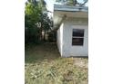 Exterior view of a dilapidated building with peeling paint and overgrown vegetation at 902 Marshall St, Clearwater, FL 33755