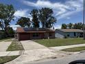 Charming single-story brick home with solar panels, a one-car garage and a well-maintained lawn at 902 Marshall St, Clearwater, FL 33755