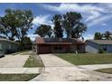 Charming single-story brick home with solar panels, a one-car garage and a well-maintained lawn at 902 Marshall St, Clearwater, FL 33755