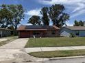 Charming single-story brick home with solar panels, a one-car garage and a well-maintained lawn at 902 Marshall St, Clearwater, FL 33755