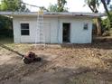 Detached garage needing repair showing open doorway and ladder at 902 Marshall St, Clearwater, FL 33755