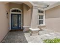 Welcoming front entrance with an elegant glass-paneled door and stone pathway at 10435 Deerberry Dr, Land O Lakes, FL 34638