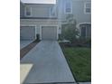Inviting townhome showcasing a manicured lawn, gray exterior, and a convenient attached garage at 10573 Oakside Dr, Palmetto, FL 34221