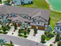Aerial view of townhomes with well maintained landscaping, trees and sidewalks on a sunny day at 11287 Cay Spruce Way, San Antonio, FL 33576
