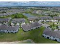 An aerial view of townhomes next to ponds, wetlands and a neighborhood at 11287 Cay Spruce Way, San Antonio, FL 33576