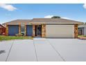 Beautiful single-story home boasting a two-car garage, stone accents, and a well-manicured front lawn at 11320 Partridge Dr, Tampa, FL 33625