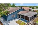 Aerial view of home with screen patio, neutral paint, and manicured yard, surrounded by a wooden fence at 11320 Partridge Dr, Tampa, FL 33625