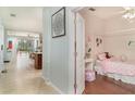 Open hallway showcases a bedroom and flows into the living area with ample natural light at 11849 Forest Park Cir, Bradenton, FL 34211
