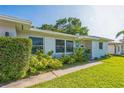 Inviting facade with tidy landscaping, brick accents, and a light-blue front door at 1220 Magnolia Dr, Clearwater, FL 33756