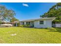 Well-maintained home showcases tidy landscaping, a lush green lawn, and a serene residential setting at 1220 Magnolia Dr, Clearwater, FL 33756