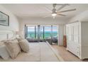 Main bedroom featuring a ceiling fan, tile flooring, and a scenic ocean view at 15000 Gulf Blvd # 901, Madeira Beach, FL 33708