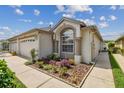 Well-maintained home exterior with a manicured lawn and tidy landscaping at 19409 Weymouth Dr, Land O Lakes, FL 34638