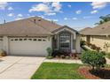 Charming single-Gathering home featuring a two-car garage and a beautifully landscaped front yard at 19409 Weymouth Dr, Land O Lakes, FL 34638