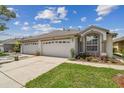 Lovely home with three-car garage and manicured lawn, showcasing curb appeal at 19409 Weymouth Dr, Land O Lakes, FL 34638