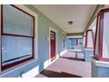 Inviting front porch with red-framed windows and matching trim provides a perfect outdoor seating area at 205 W Emma St, Tampa, FL 33603