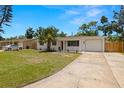 Well-maintained single-story home with a mature palm tree, a one car garage and concrete driveway at 2066 62Nd Pl S 62Nd Pl, St Petersburg, FL 33712