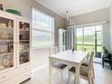 Bright dining area features stylish chandelier and sliding glass door access at 2190 Great Sapphire Ln, Lutz, FL 33558
