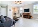 Inviting living room with tile flooring, neutral walls, and cozy sofa at 2190 Great Sapphire Ln, Lutz, FL 33558