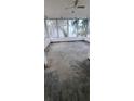 Enclosed sun room featuring ceiling fan and open windows at 2469 Trade Winds Dr, Dunedin, FL 34698