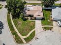 An aerial shot of a residential house highlighting its landscaped yard, driveway, and proximity to the street at 3242 Brushwood Ct, Clearwater, FL 33761