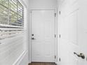 Bright entryway with white door and closet, and wood-look floors at 3305 Haviland Ct # 101, Palm Harbor, FL 34684