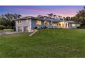 View of the home's exterior featuring a two-car garage and well-manicured lawn at 3425 W Forest Lake Cir, Sarasota, FL 34232